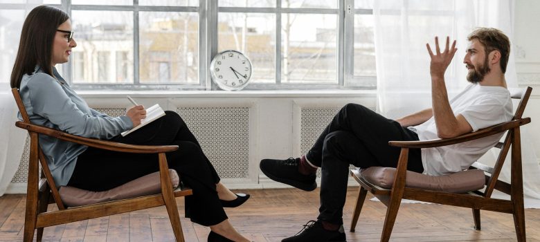 Students studying psychology in a university classroom, engaged in discussion